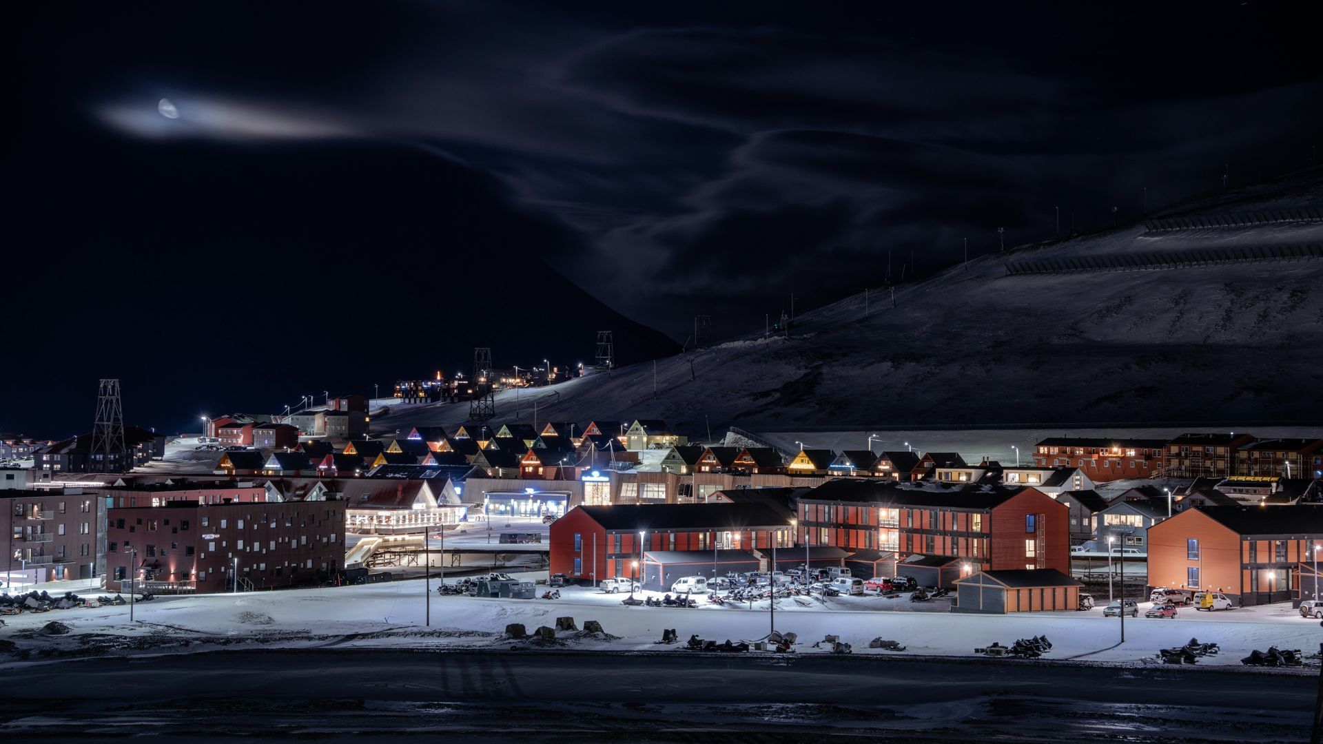An aerial view of a snowy town at night