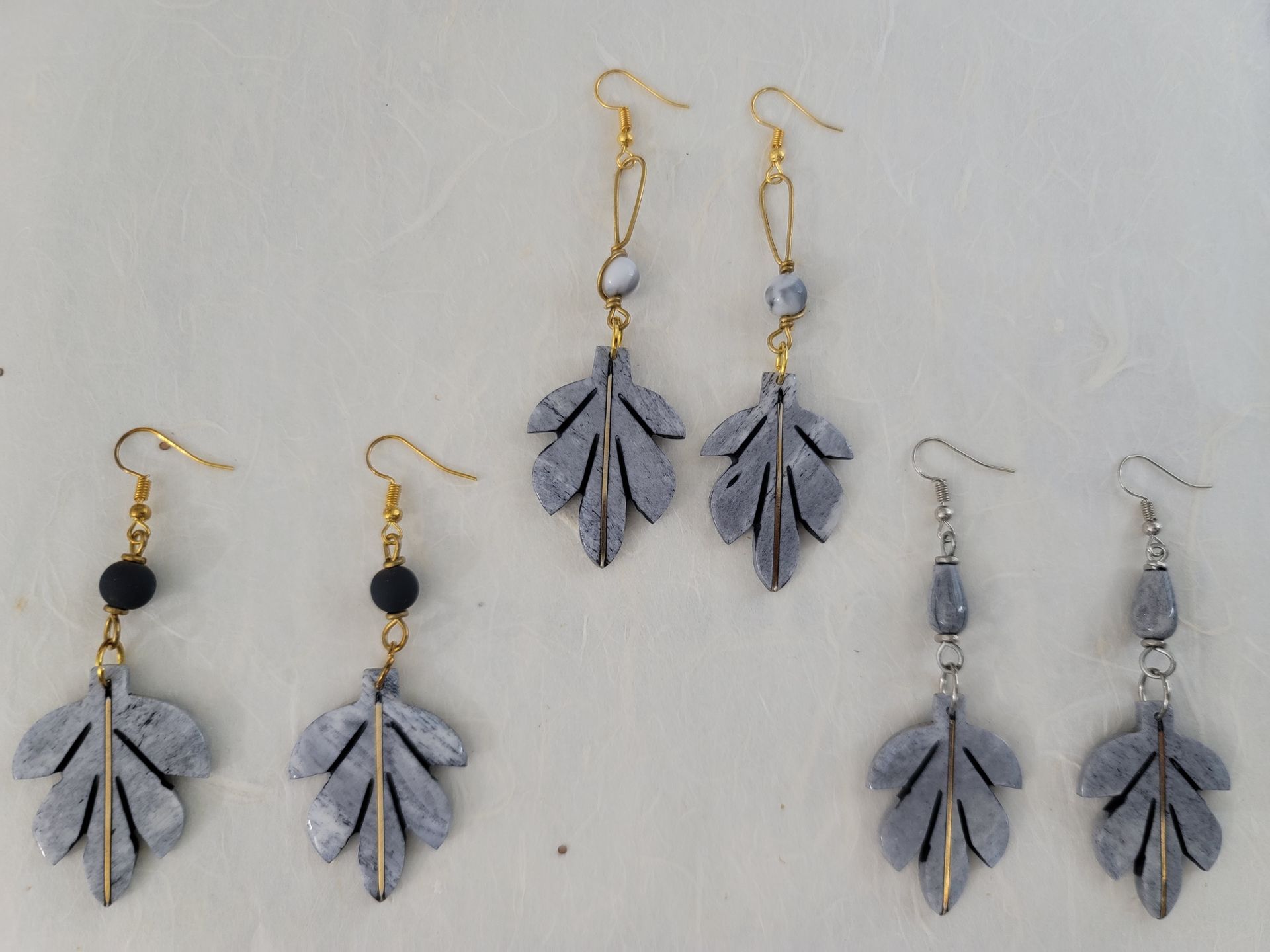 Ankole cow horn earrings, handmade bone earrings, ethical jewelry, African-inspired jewelry, artisan-crafted earrings, sustainable fashion accessories.