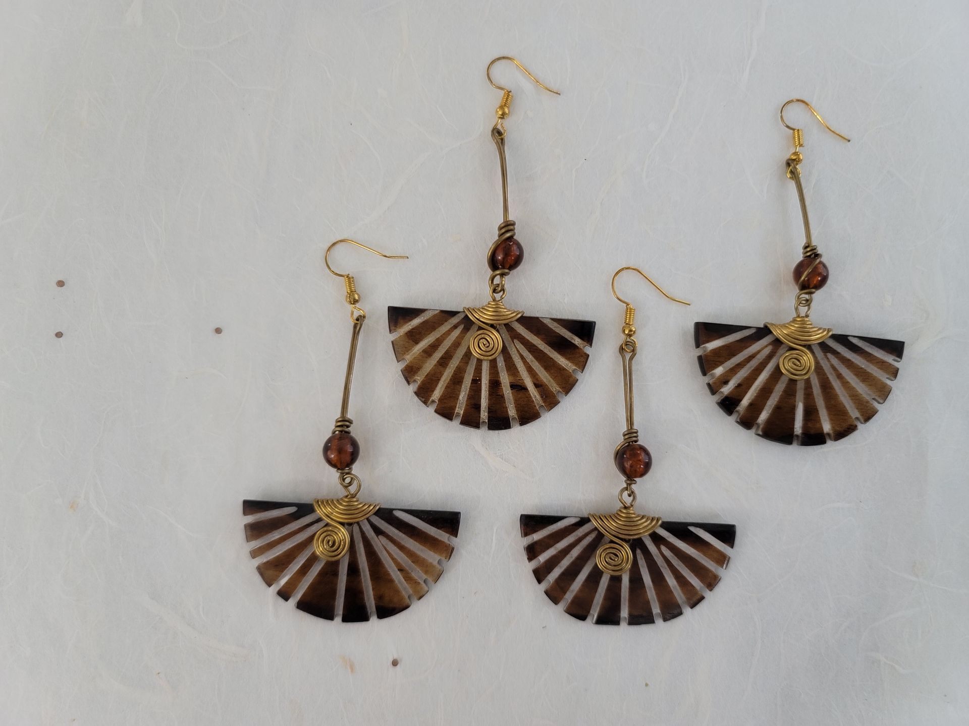 Ankole cow horn earrings, handmade bone earrings, ethical jewelry, African-inspired jewelry, artisan-crafted earrings, sustainable fashion accessories.
