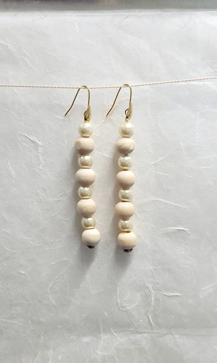 Tas Tas long drop earrings made with bamboo wood beads and simulated pearls