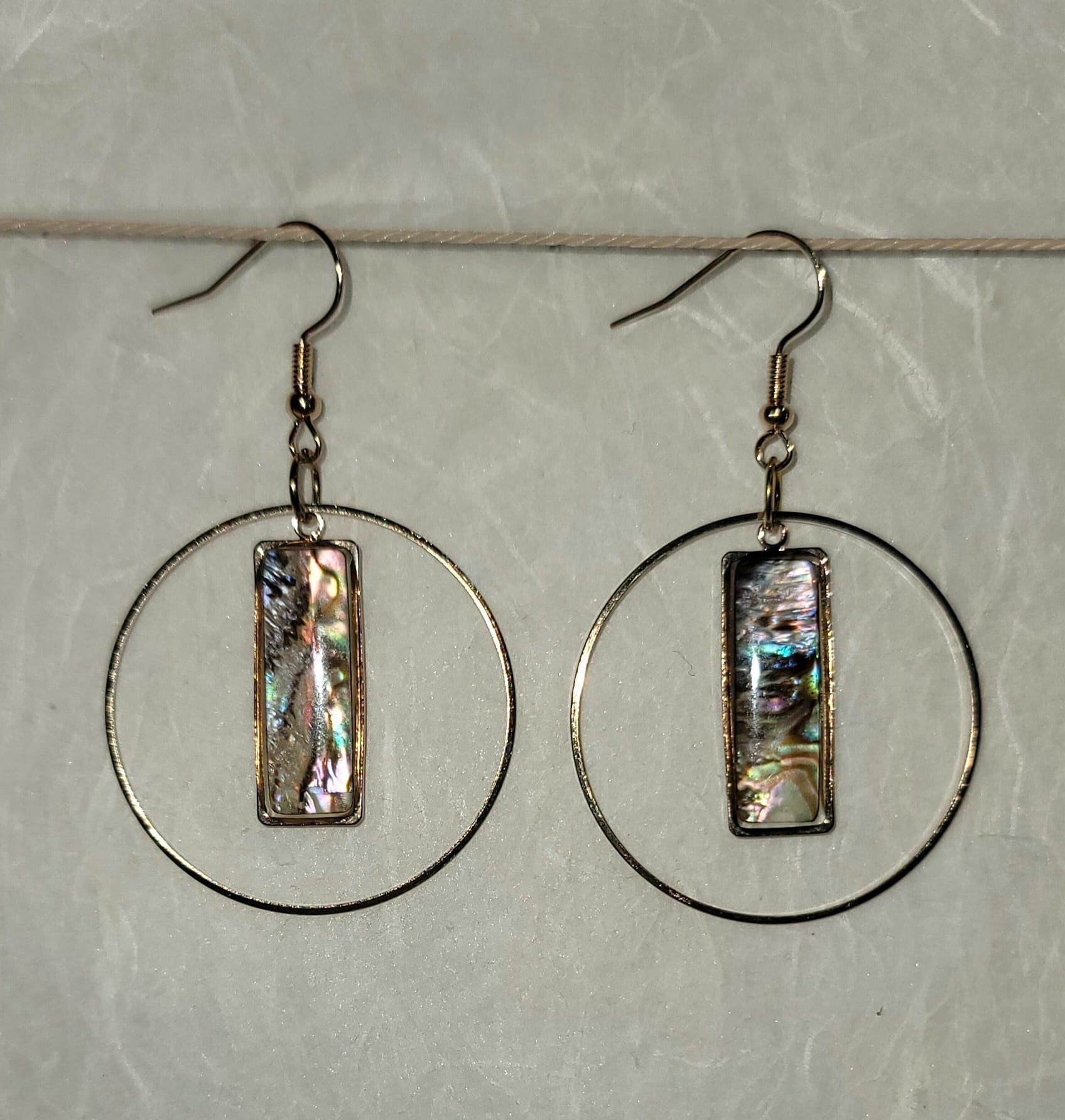 Tas Tas handmade brass hoop earrings with rectangular abalone shell centers and gold-plated posts