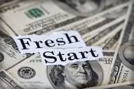 Dollar bills with the words “Fresh Start” in bold black text.