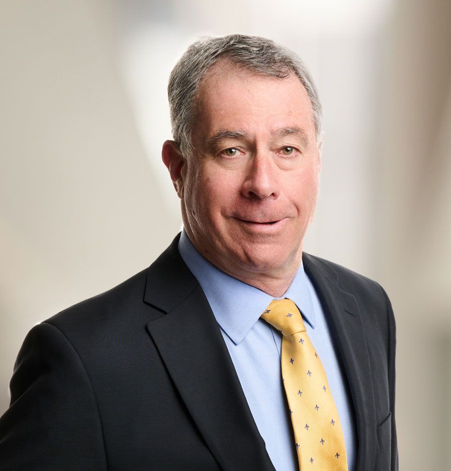 a man in a suit and red tie is smiling for the camera .