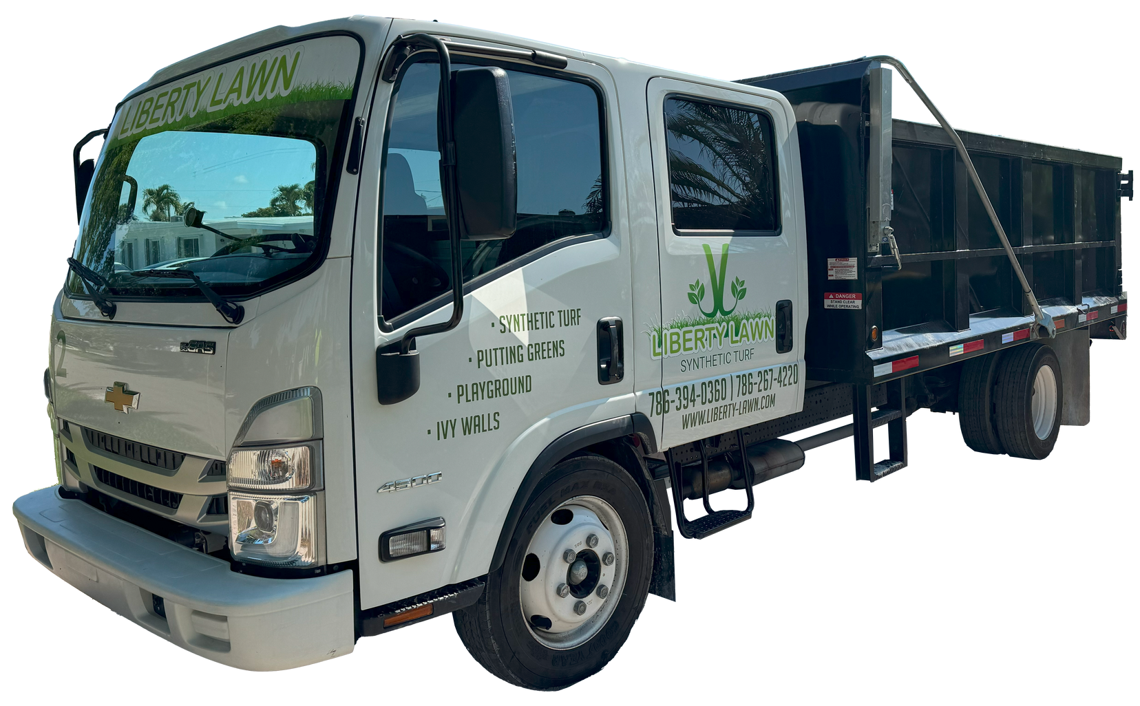 A white truck with a green logo on the side is parked on a white background.