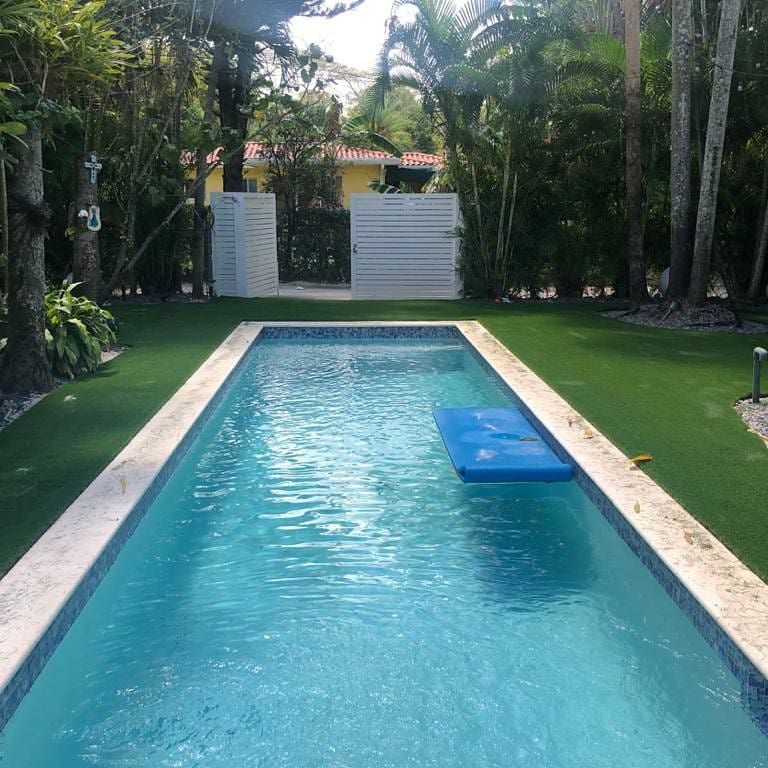 A large swimming pool with a blue raft in the middle of it