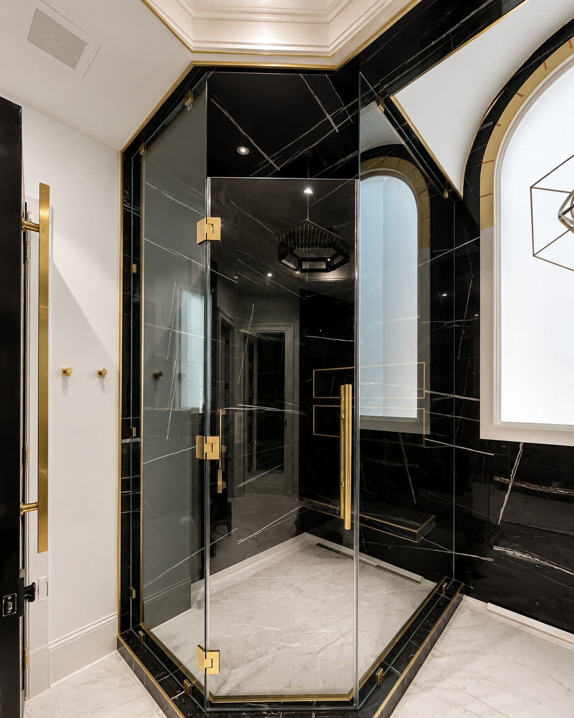 Black-framed glass shower enclosure with gold hardware in a modern bathroom