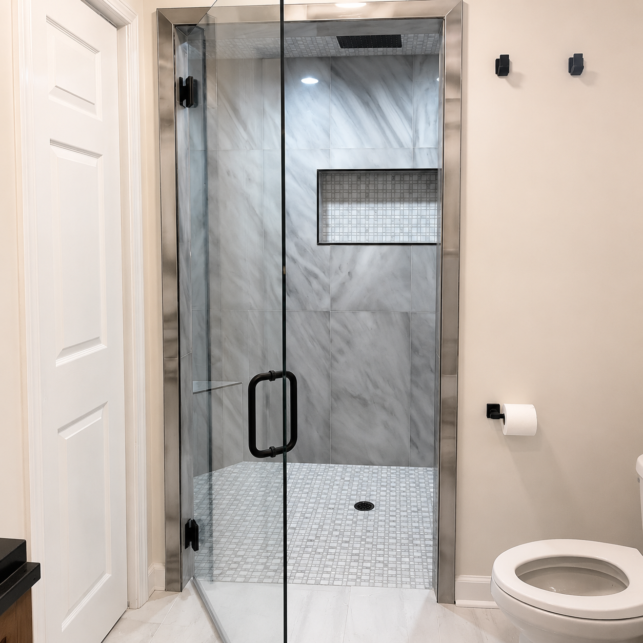 Bright marble bathroom with glass shower, freestanding tub, and large window
