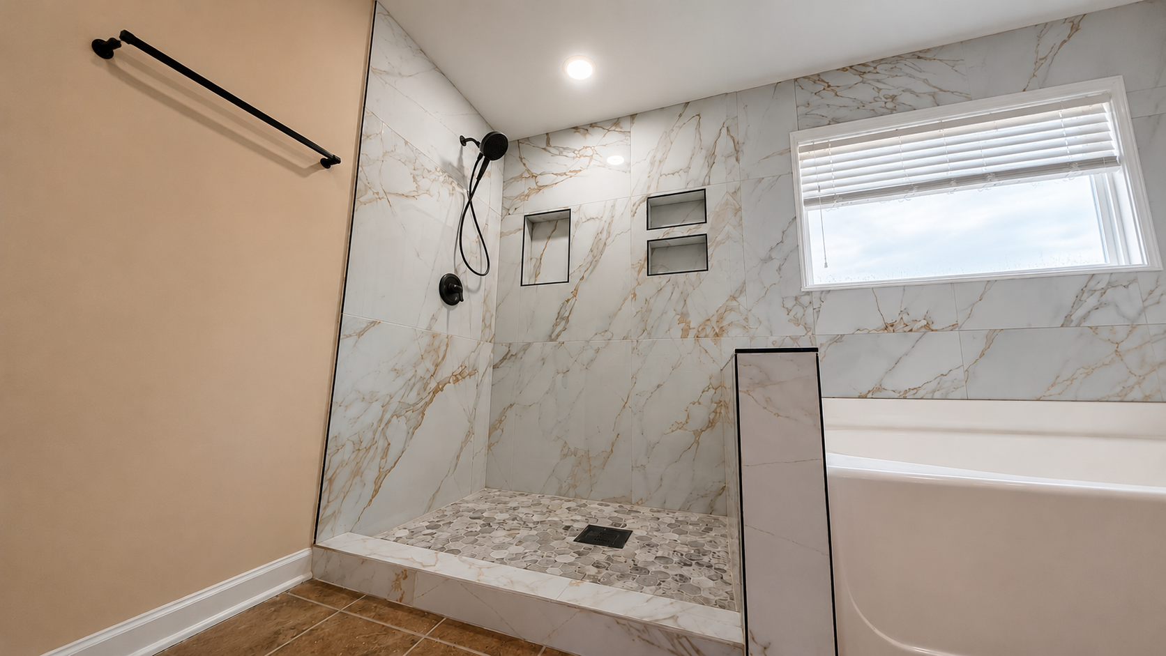 Modern bathroom with marble tile, walk-in shower, tub, and window blinds