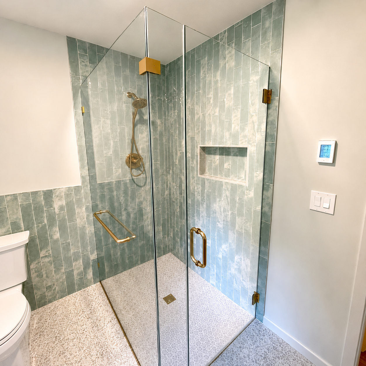 Bright marble bathroom with glass shower, freestanding tub, and large window