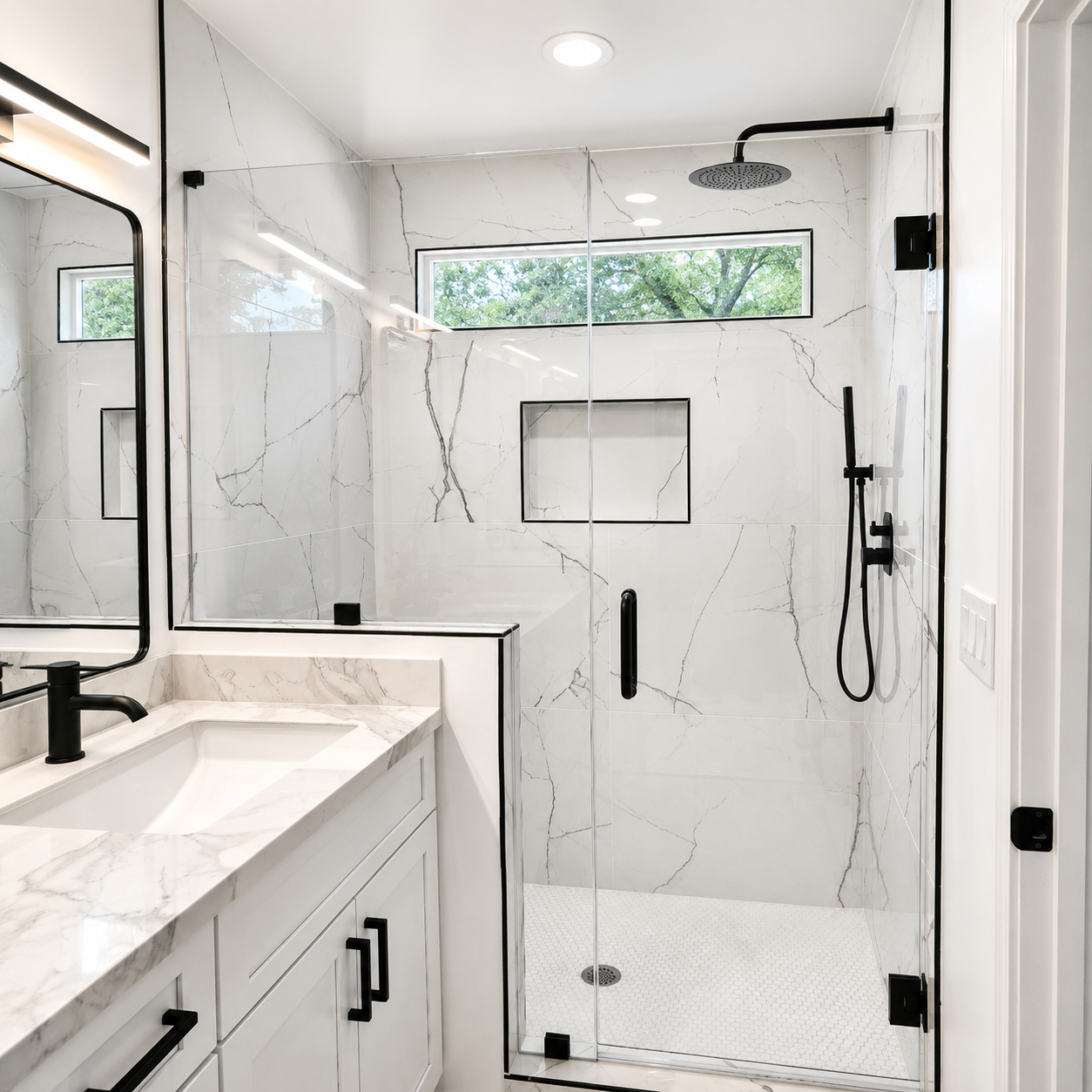 Modern white marble bathroom with glass shower, black fixtures, and double vanity