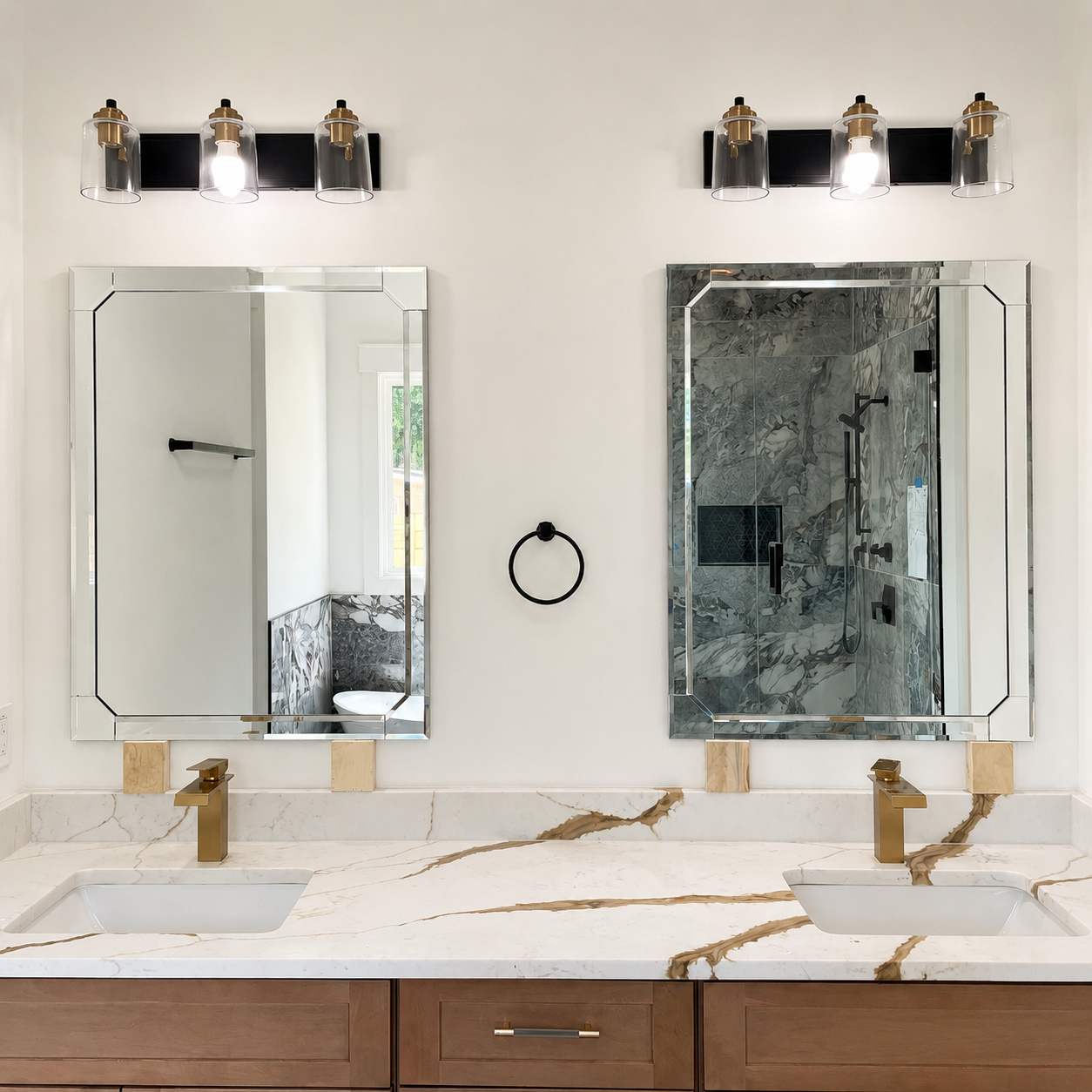 Modern bathroom double vanity with two mirrors, brass faucets, and marble countertop