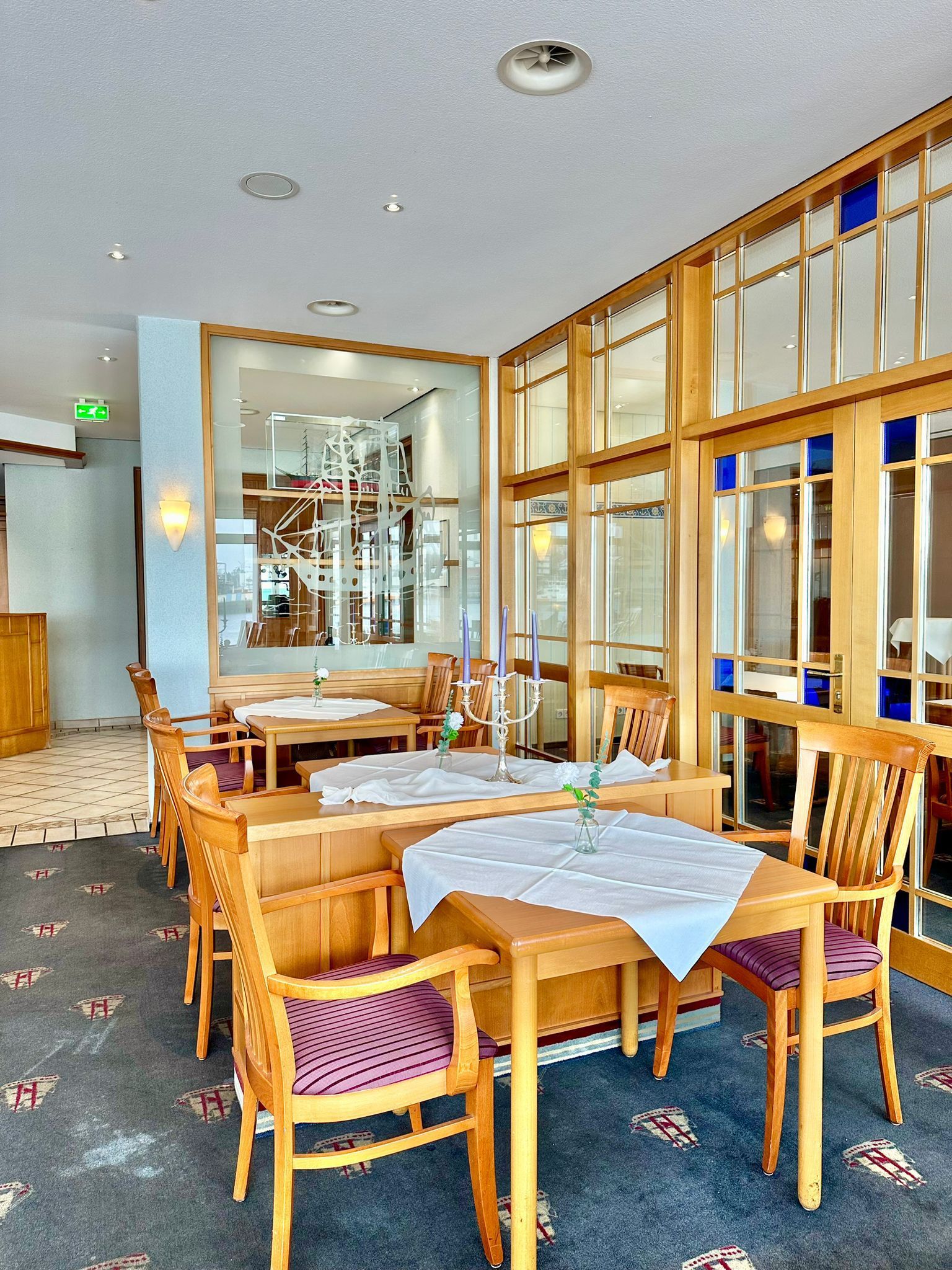 Ein Restaurant mit Tischen und Stühlen und Buntglasfenstern