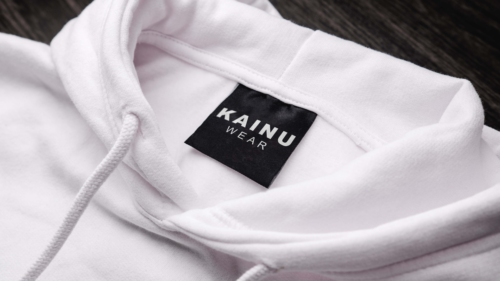 A close up of a white hoodie with a label on it.