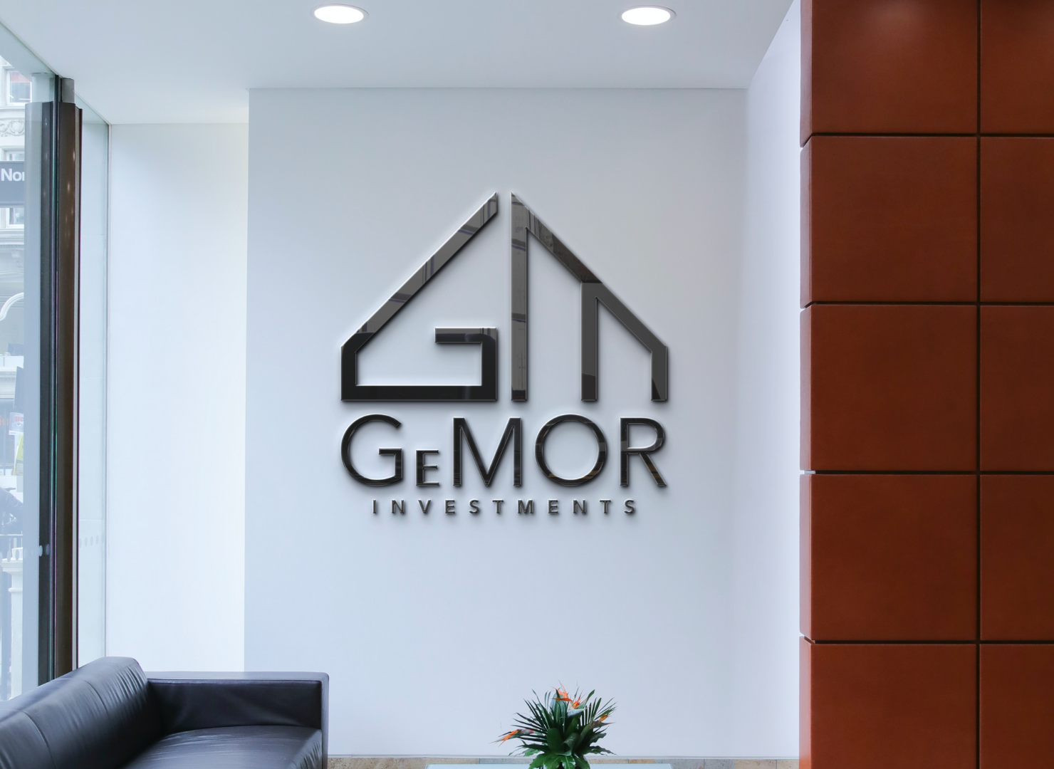 A room with a couch and a sign that says gm gemor investments