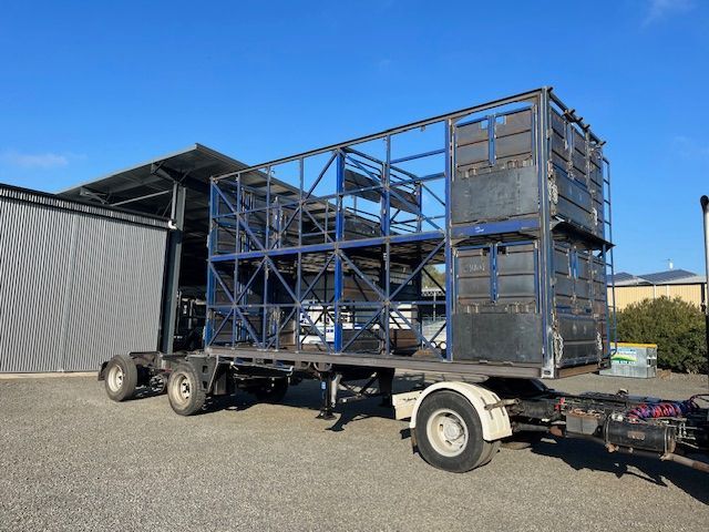 A Large Blue and White Stick crates on a trailer— Deveigne Fabrications In Brocklehurst, NSW