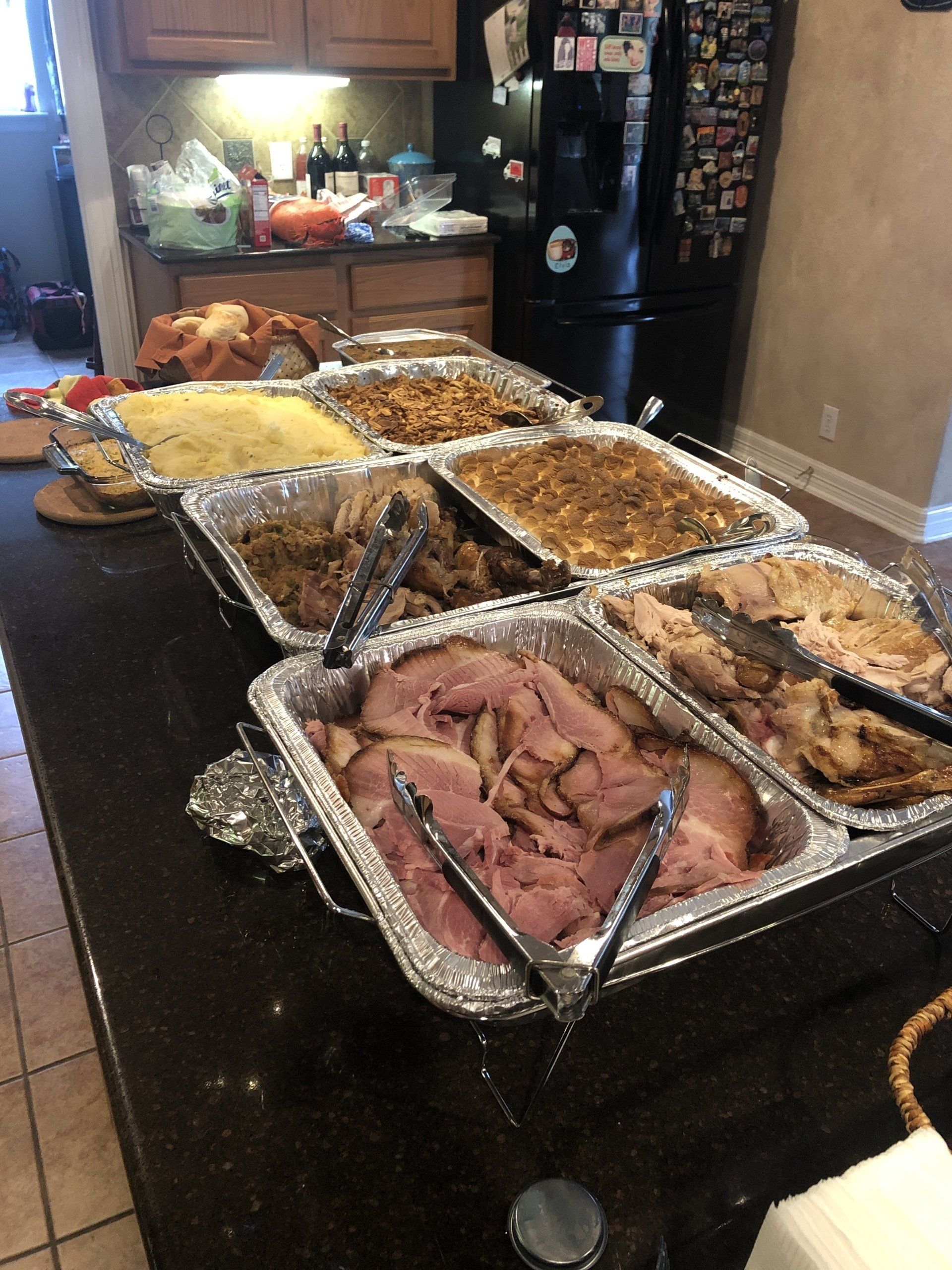 A buffet table with a variety of food on it.