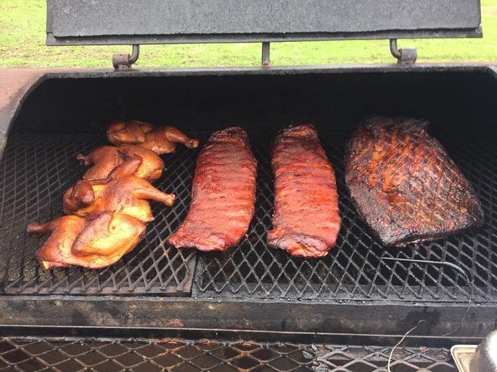 three different types of meat are cooking on a grill