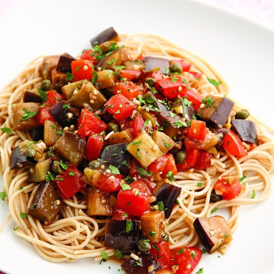 A white plate topped with noodles and vegetables