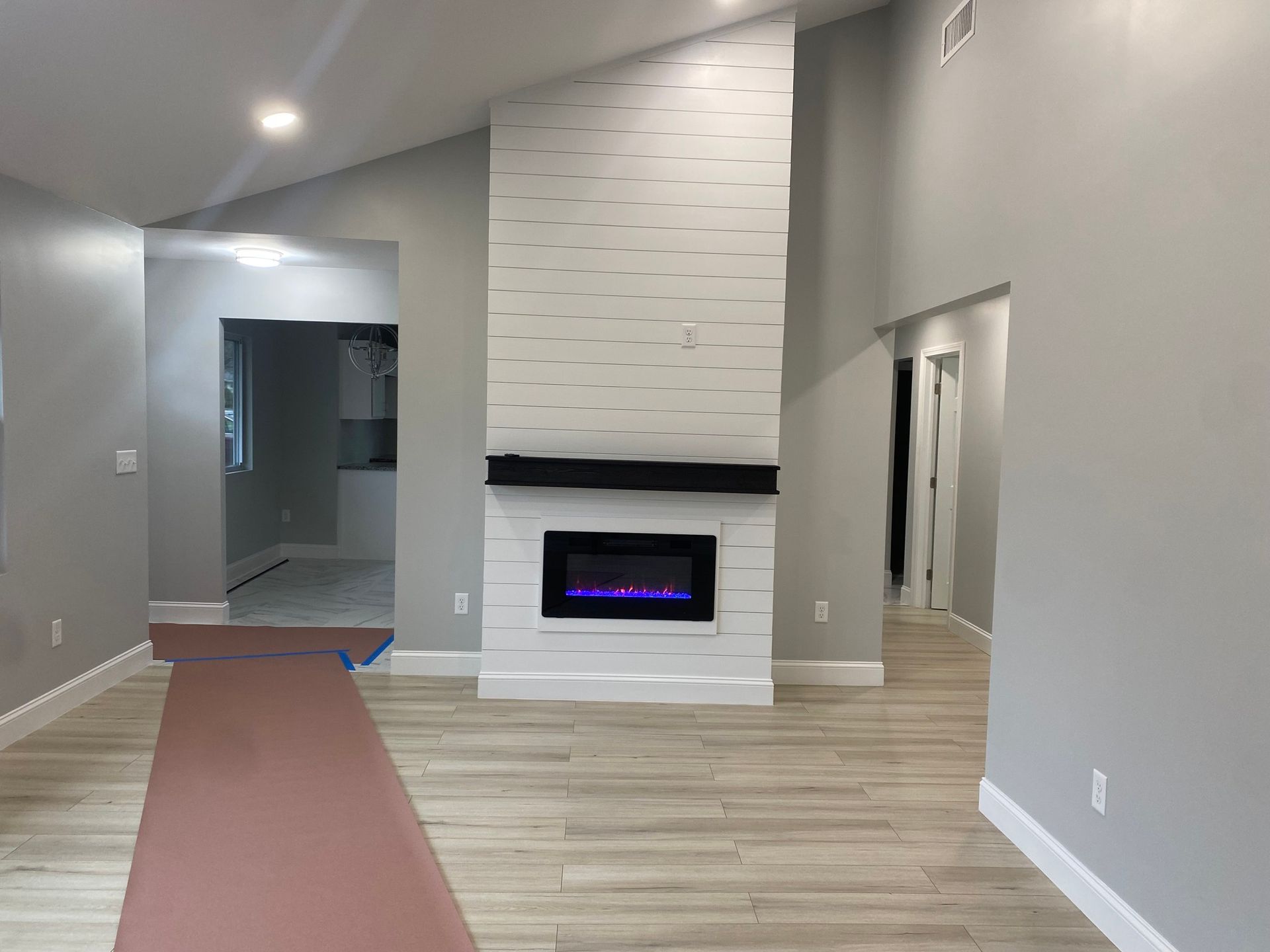 There is a fireplace in the middle of the living room.