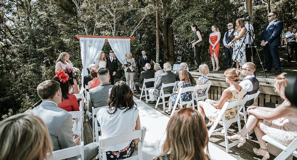 A group of people are sitting in chairs at a wedding ceremony.