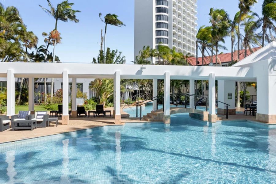 A large swimming pool with a building in the background