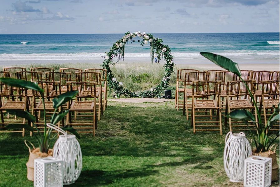 A wedding ceremony is taking place on the beach.