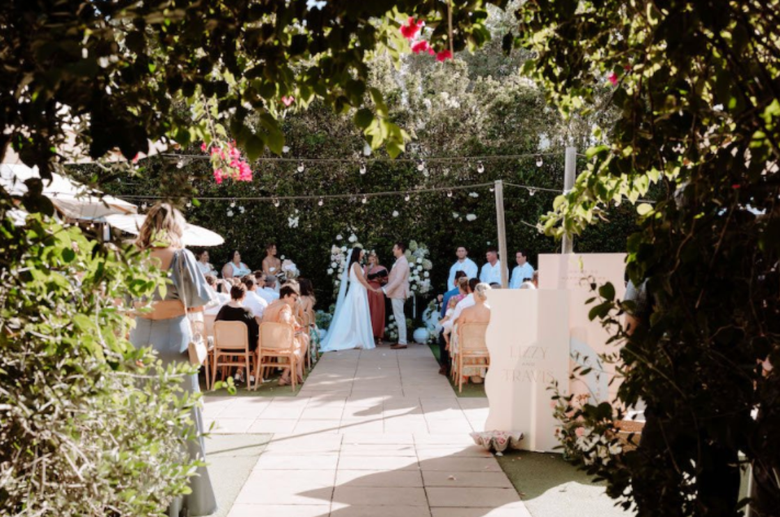 A group of people are sitting in chairs at a wedding ceremony.