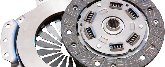 Two automotive clutch discs, one silver and one dark gray, shown side by side on a white background | Dunedin Total Car Care
