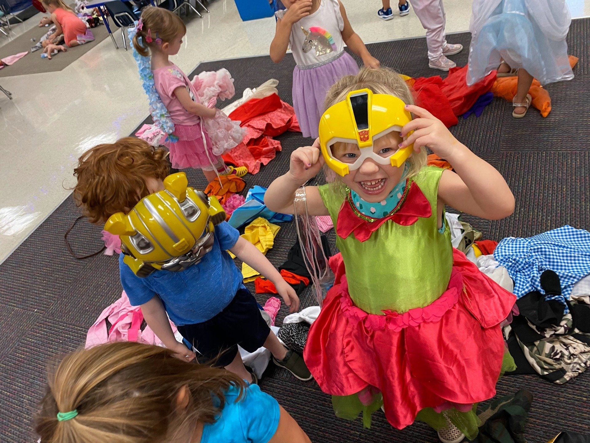 A group of children are dressed up in costumes and masks.