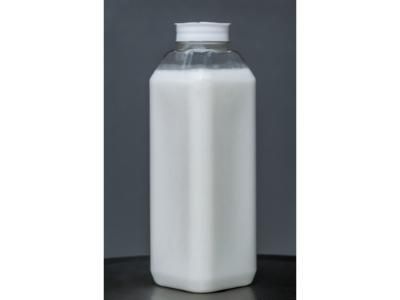 White plastic bottle with a ribbed cap on a dark background