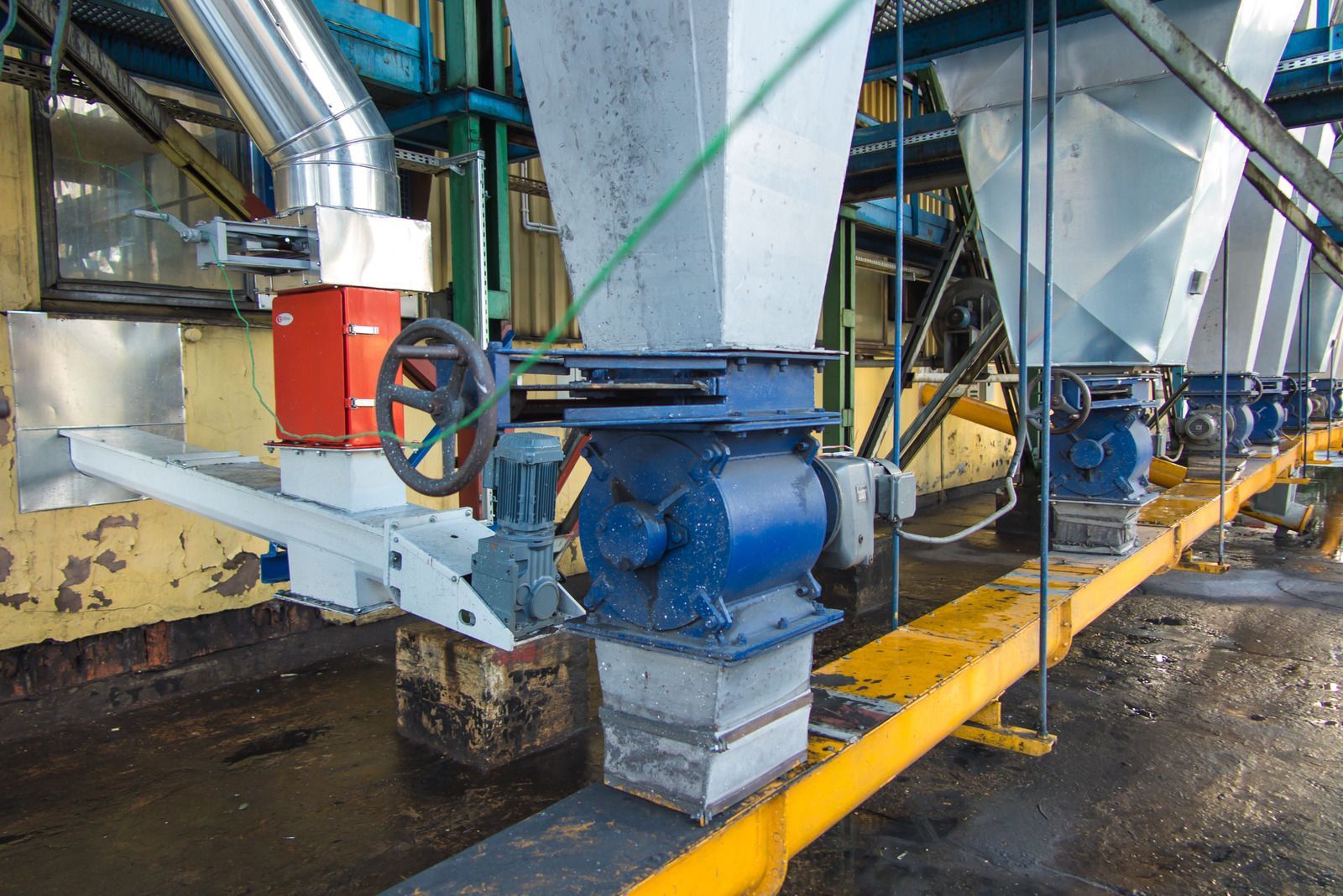 A row of blue and white machinery in a factory