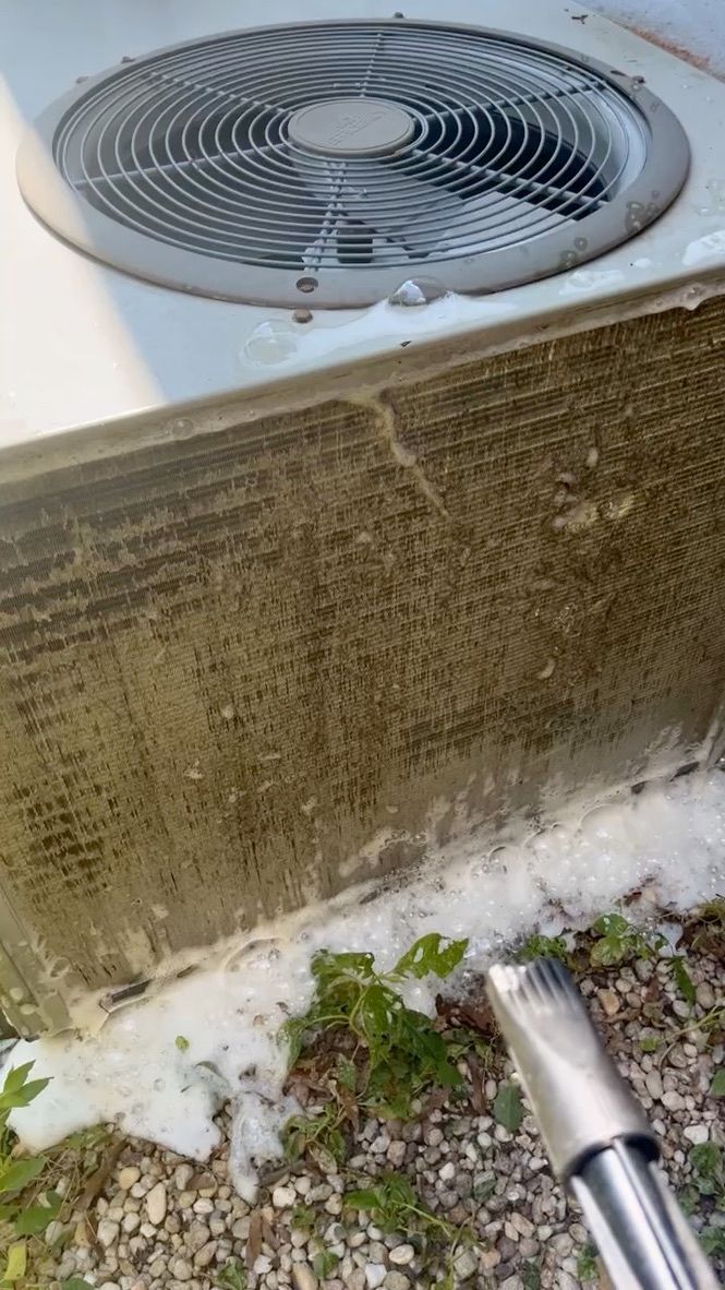 Dirty outdoor HVAC unit with a frosted coil and snow buildup at the base