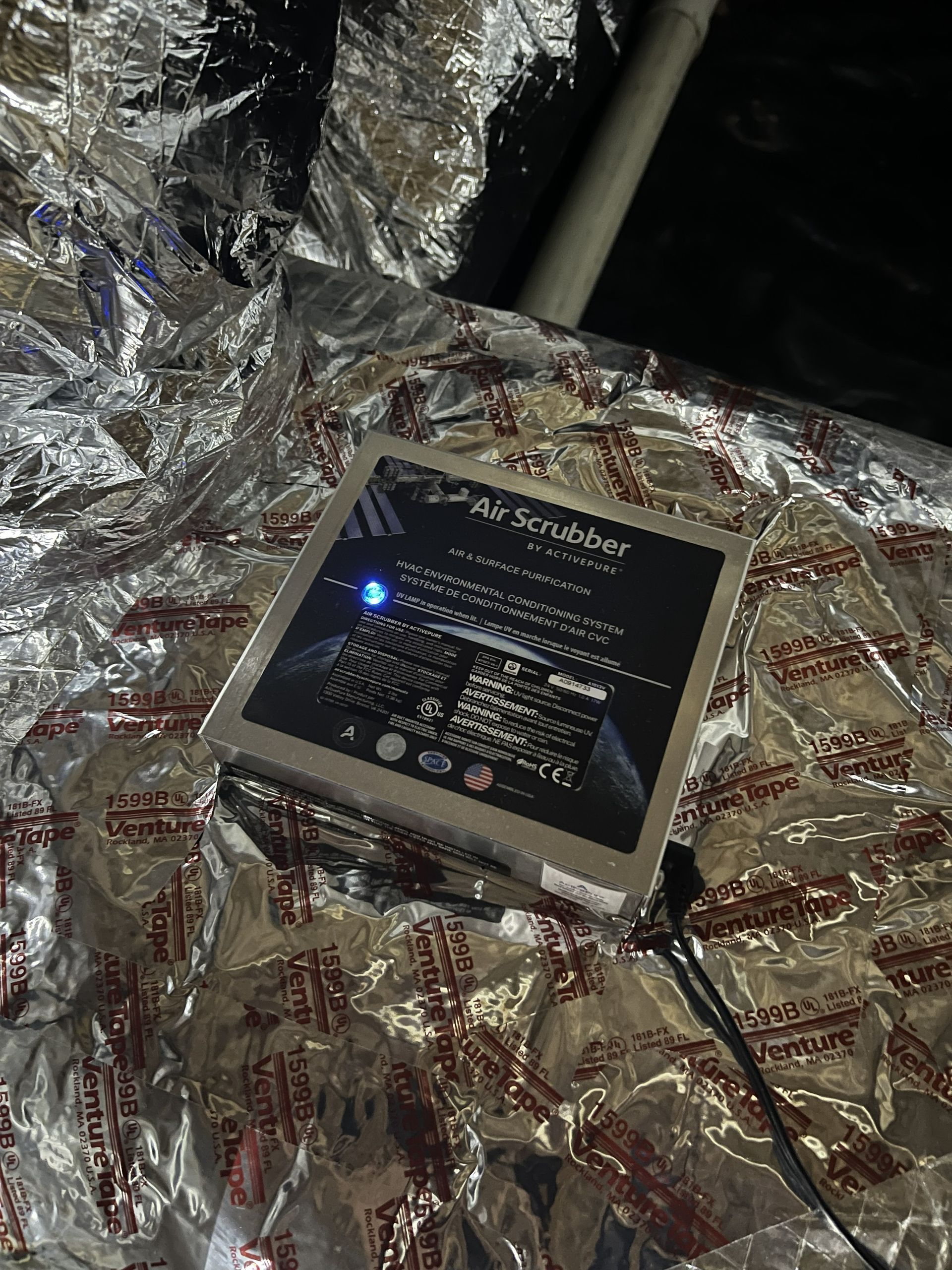 Solar-powered electronic device with a blue LED on reflective insulation in an industrial space