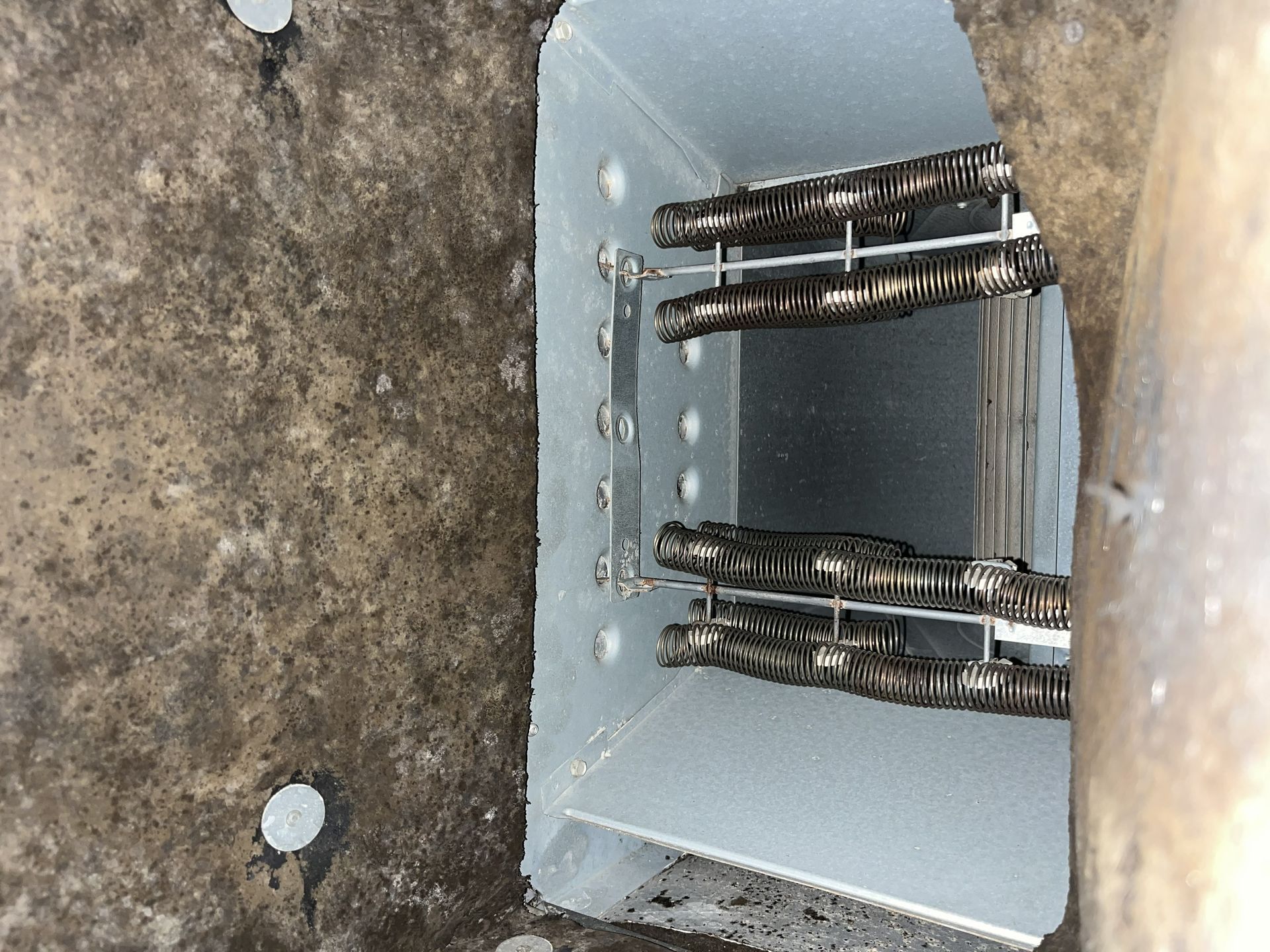 Open utility box with bundled cables inside a wall cavity