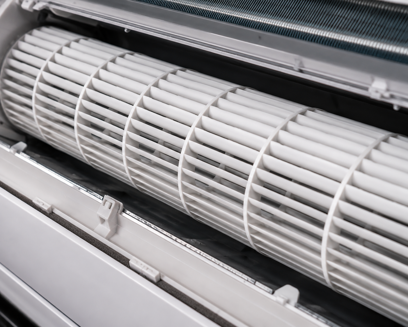 Close-up of a white cylindrical HVAC fan or filter assembly inside a metal housing