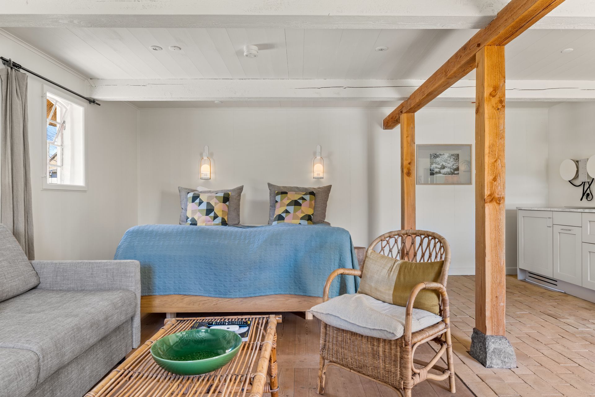 A living room with a couch , chair , table and bed.