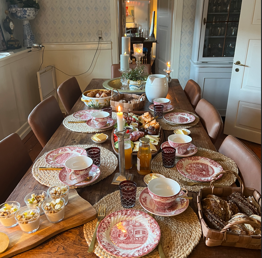 A long table with plates and cups on it