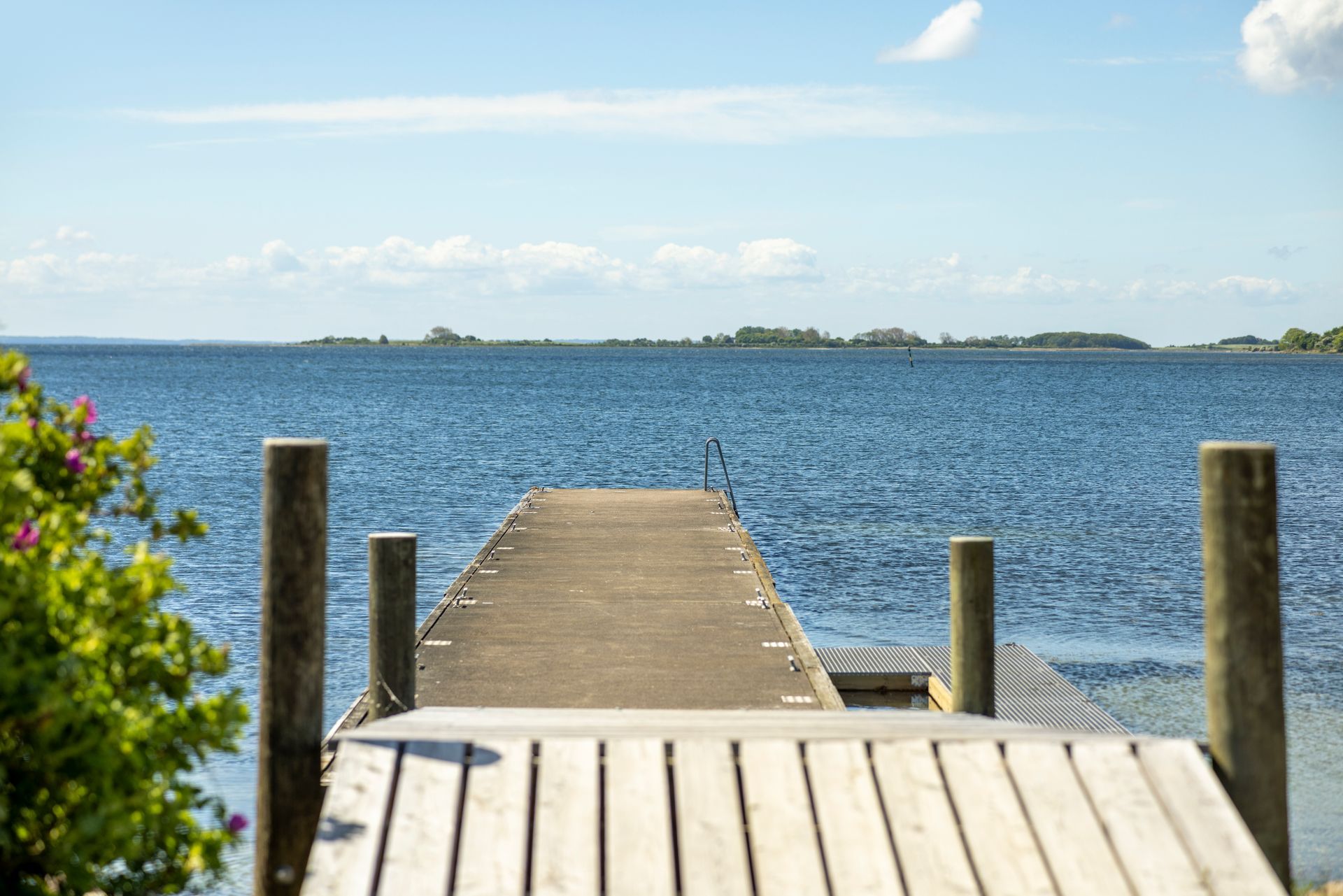 A wooden dock leading into a large body of water.