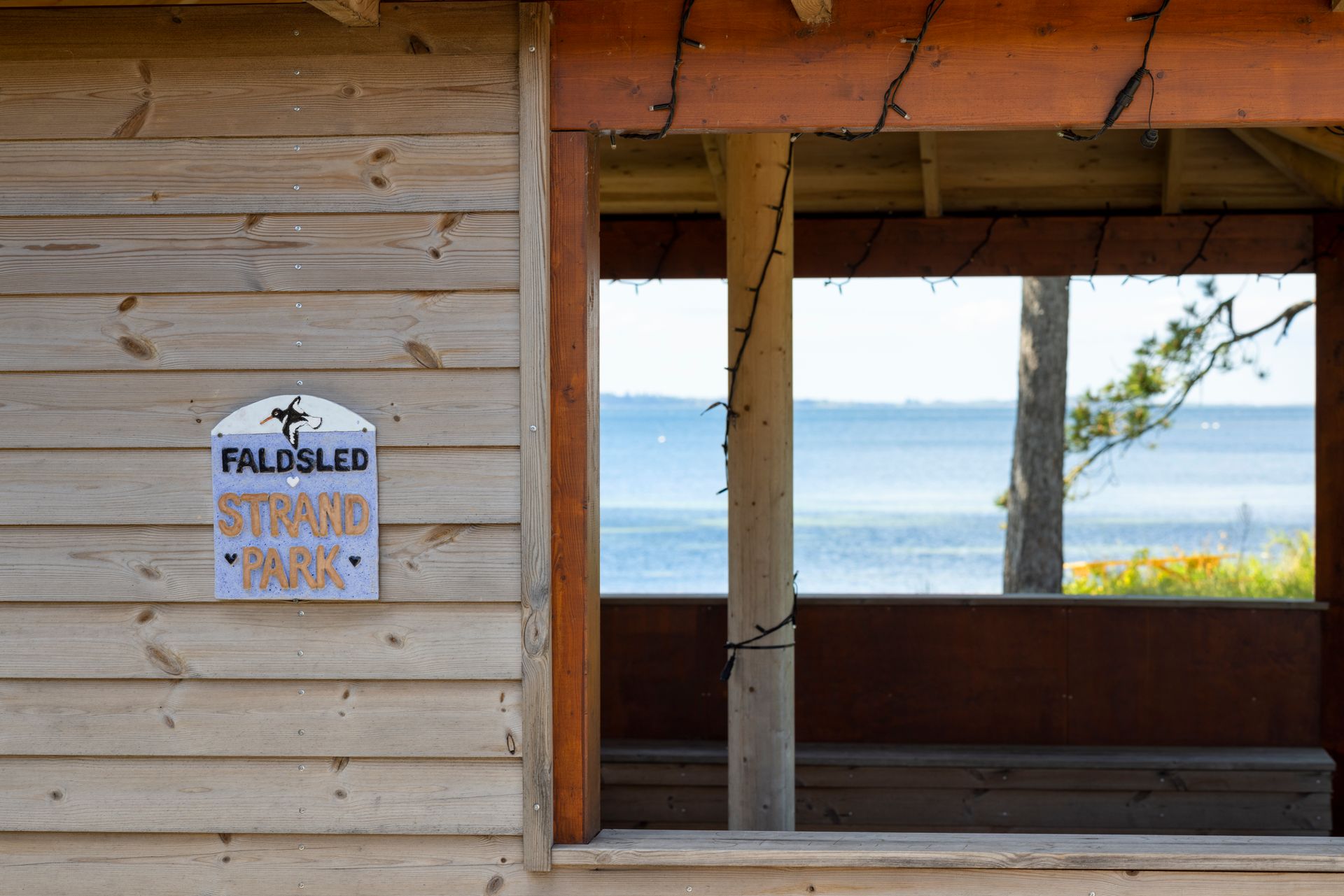 A wooden building with a sign on the side that says fields led