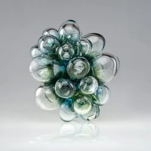 Cluster of translucent glass orbs, various sizes, shades of blue and clear.