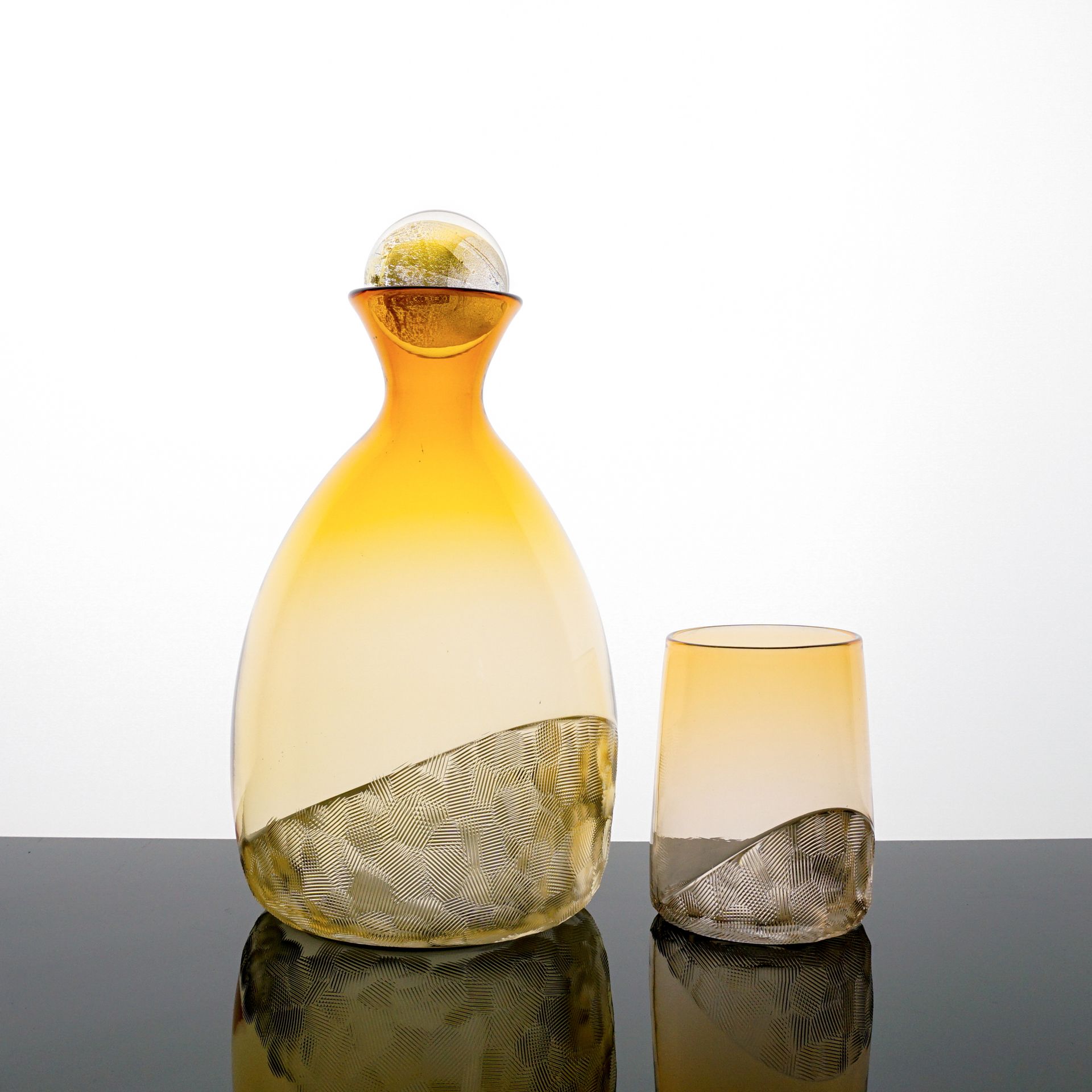 Yellow and clear glass decanter and tumbler set with textured base.