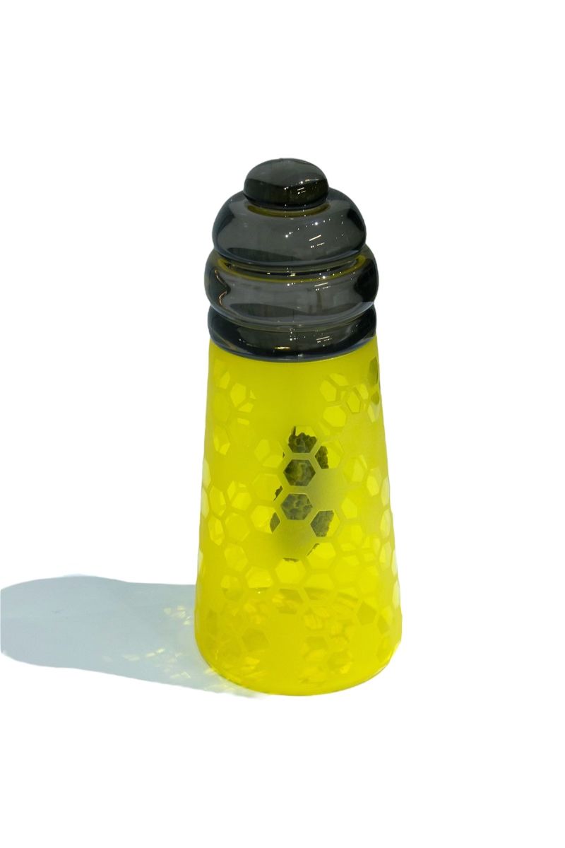 Yellow and black glass art piece with honeycomb pattern.