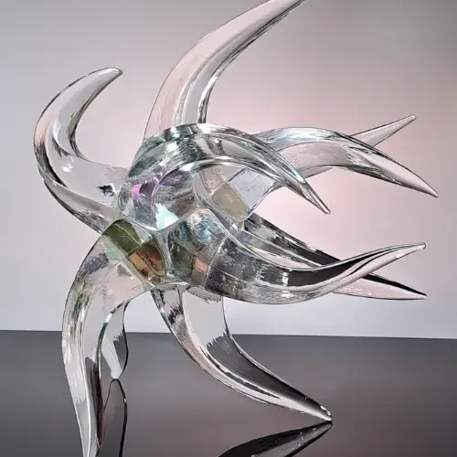Abstract glass sculpture with multiple curving arms, reflecting light.