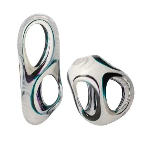 Two abstract glass sculptures with swirling white, purple, and teal patterns.
