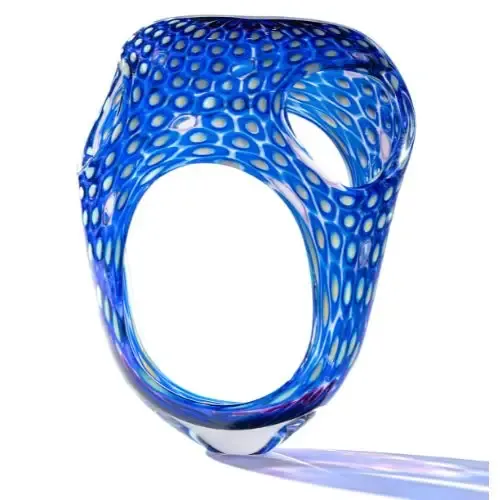 Blue and white patterned art glass sculpture with two large openings.