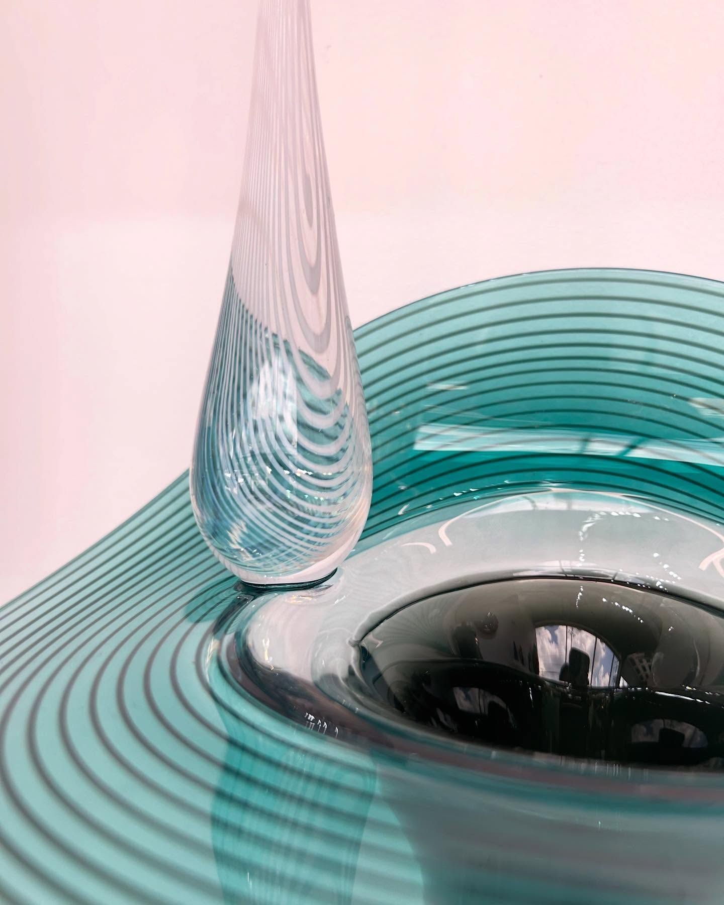 Teal and white art glass sculpture. Tear-drop shaped vase next to a bowl with concentric circles.