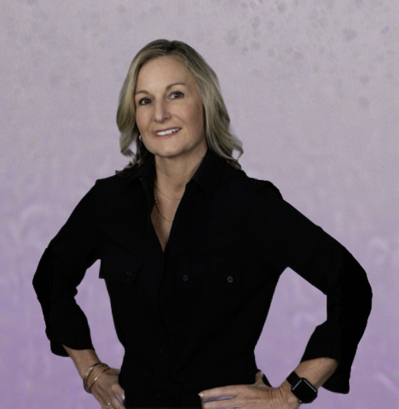 A woman in a black shirt is standing with her hands on her hips