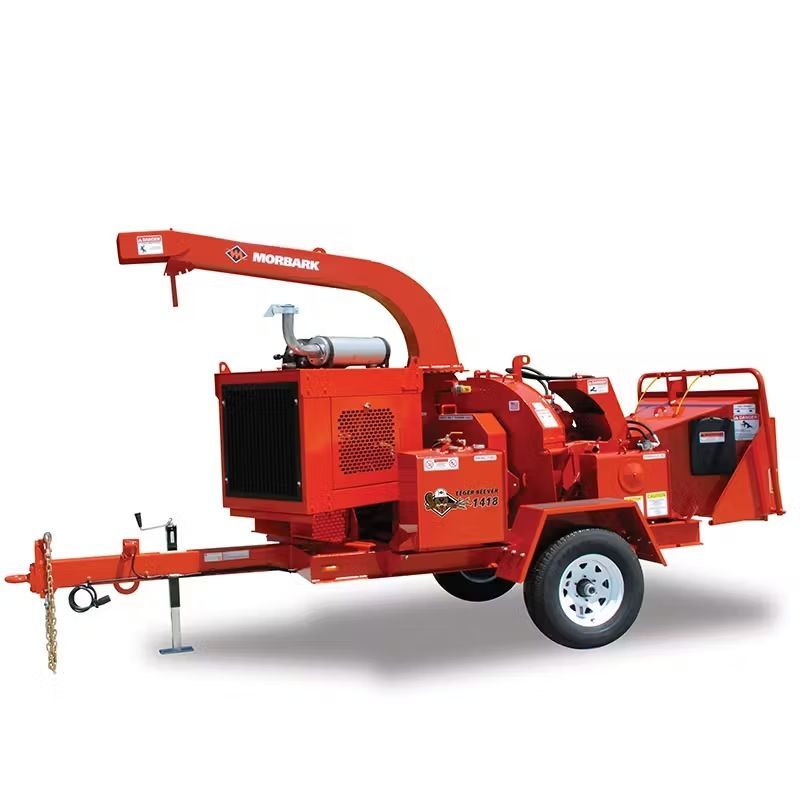 A red tree chipper on a trailer on a white background