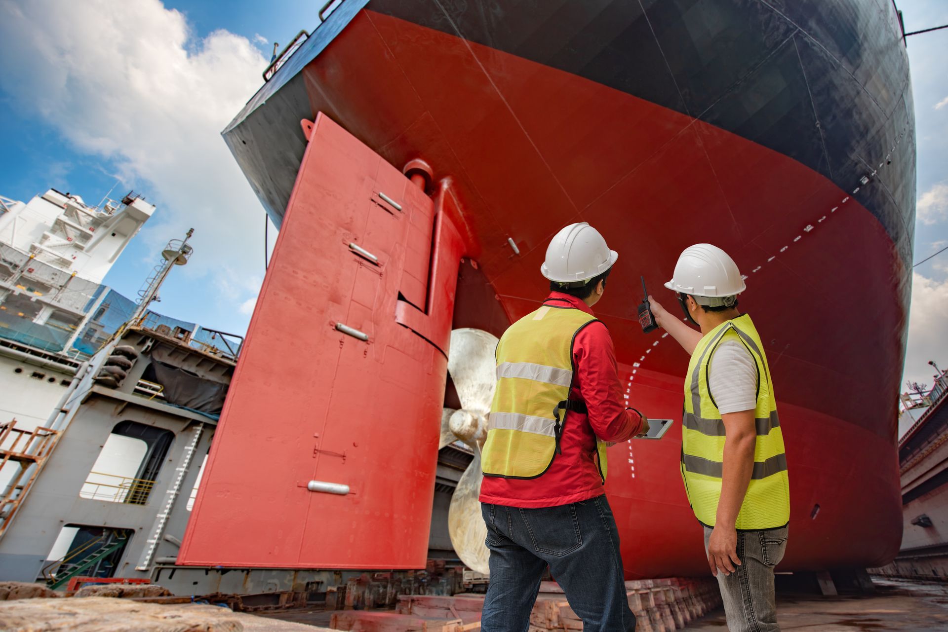 Two men are standing in front of a large ship - Portland, OR - Drew Paints Inc.