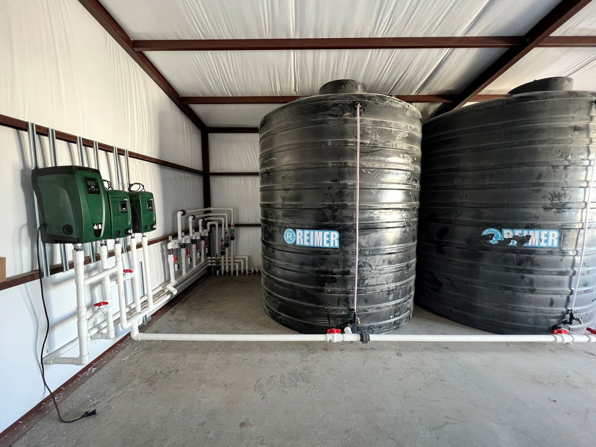 A blue water tank is sitting on top of a concrete pole in a dirt field — Seminole, TX — Shpuetz Drilling